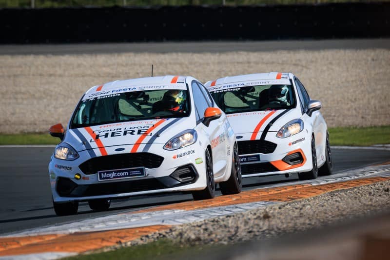 Two Fiesta Sprint Cup cars nose to tail on track