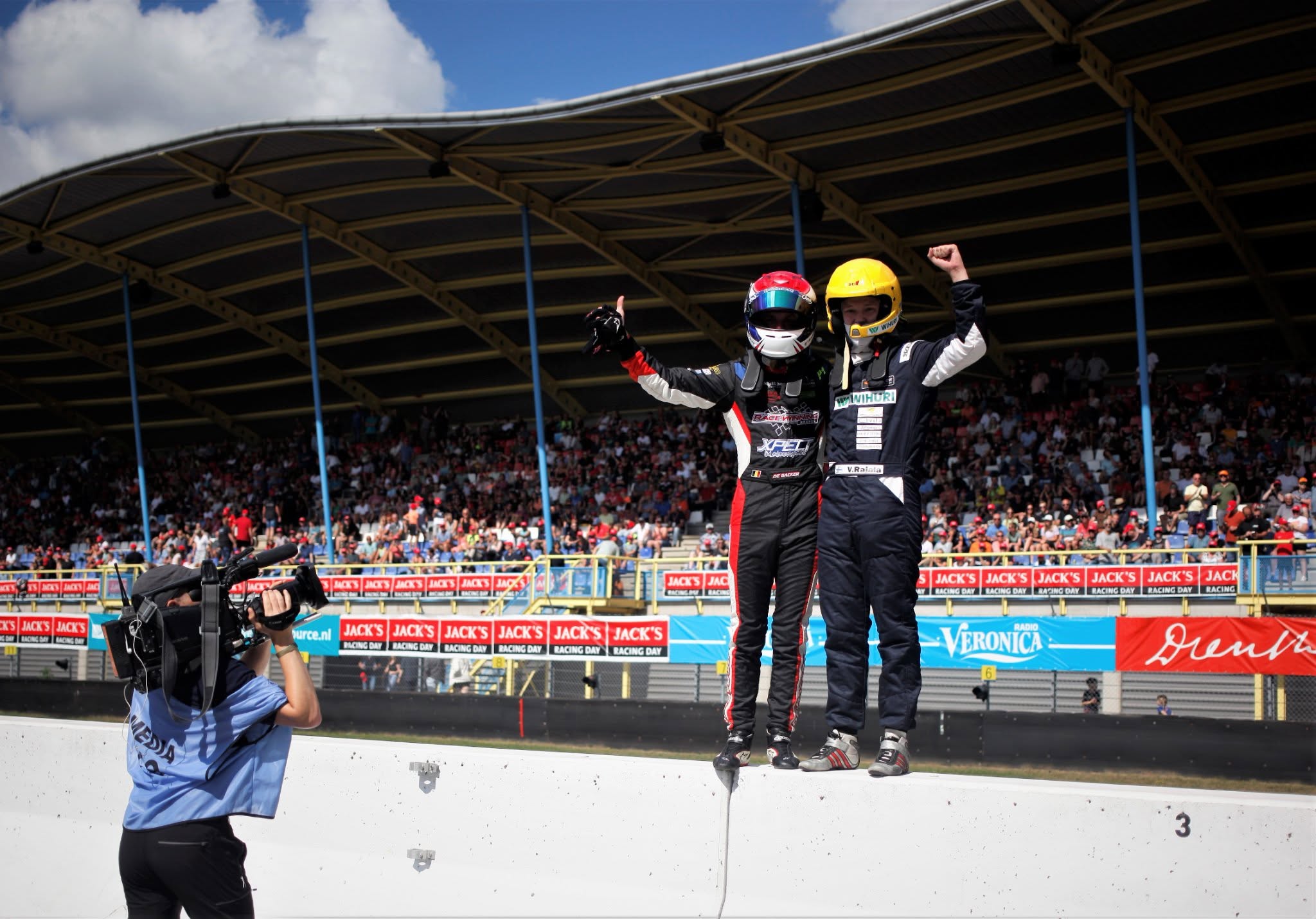 De Backer and Rajala celebrating a race win on the podium wall